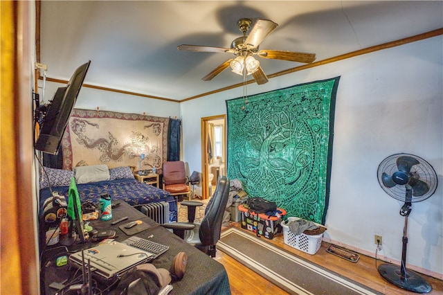 home office with hardwood / wood-style floors, ceiling fan, and crown molding