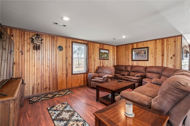 living room with hardwood / wood-style floors and wood walls