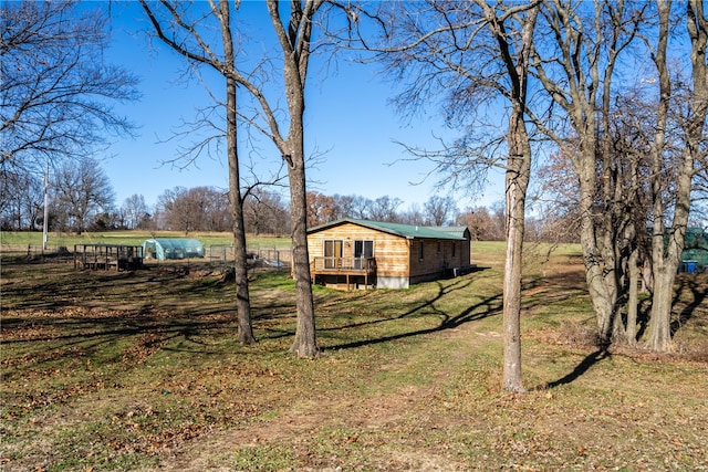 view of yard featuring a rural view and a deck