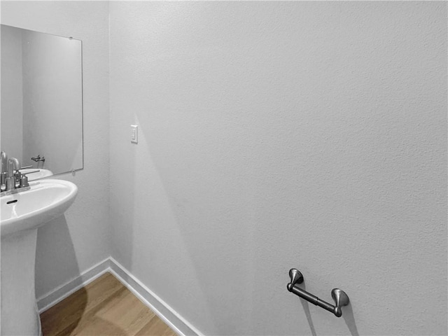 bathroom featuring hardwood / wood-style flooring and sink