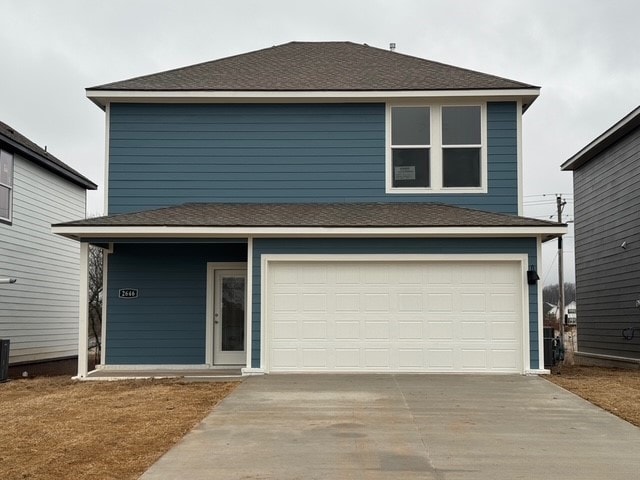 view of front property with a garage and central air condition unit