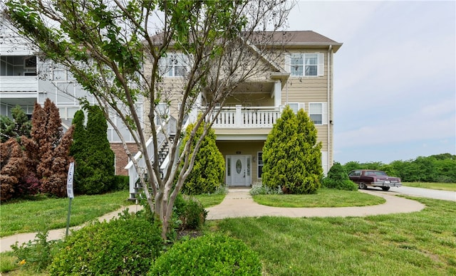 180 Grace Chapel Unit 107, Blue Eye, MO 65611 - view of front facade featuring a front lawn and a balcony