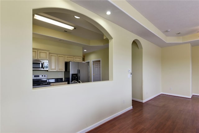 180 Grace Chapel Unit 107, Blue Eye, MO 65611 - kitchen featuring stainless steel appliances, cream cabinets, and dark hardwood / wood-style flooring