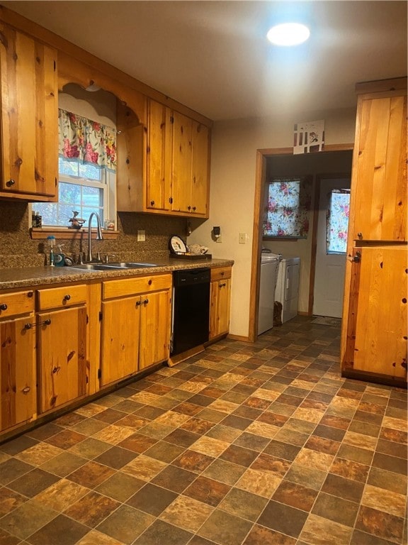 kitchen with dishwasher, washer and clothes dryer, sink, and backsplash