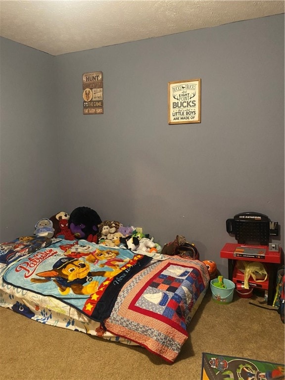 bedroom with a textured ceiling and carpet flooring