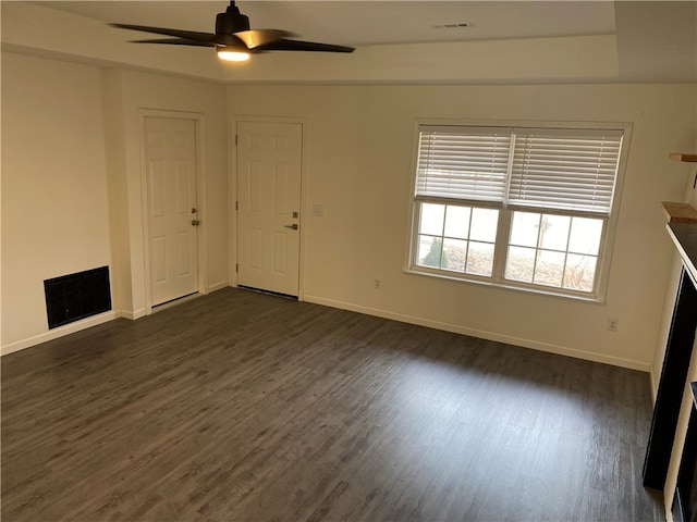 unfurnished living room featuring ceiling fan and dark hardwood / wood-style floors