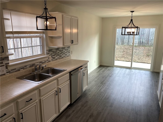 kitchen featuring sink, stainless steel dishwasher, a chandelier, and decorative light fixtures