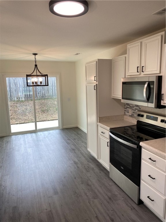 kitchen featuring stainless steel appliances, dark hardwood / wood-style floors, white cabinets, and pendant lighting