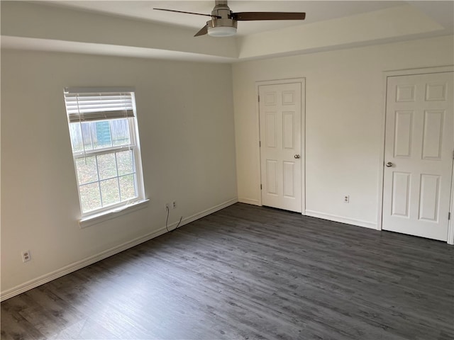 unfurnished bedroom featuring dark hardwood / wood-style flooring and ceiling fan