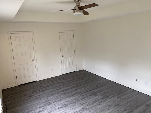 unfurnished bedroom featuring ceiling fan and dark hardwood / wood-style floors