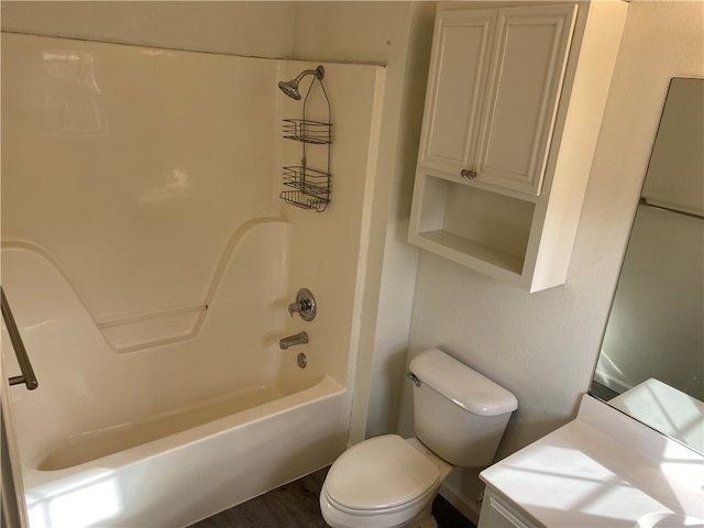 bathroom featuring hardwood / wood-style flooring, toilet, and bathing tub / shower combination