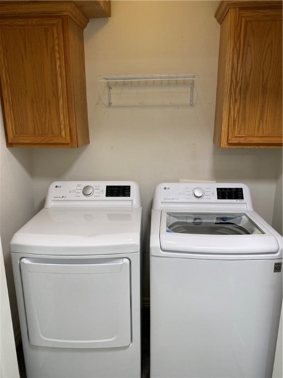 laundry room with cabinets and separate washer and dryer