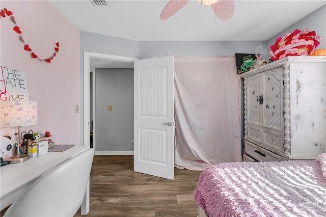 bedroom with ceiling fan and dark wood-type flooring