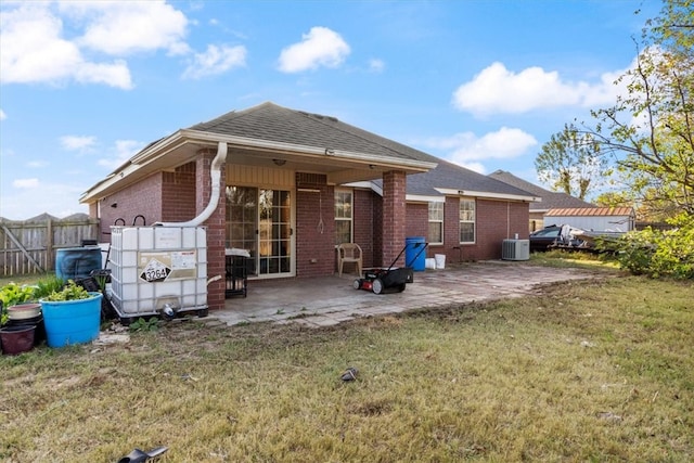 back of house with central AC, a yard, and a patio area