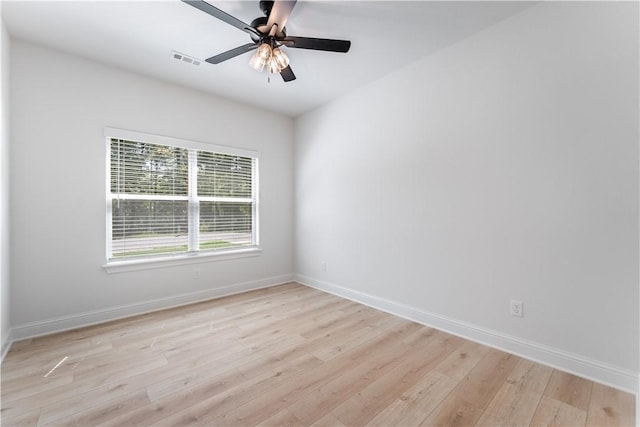 empty room with ceiling fan and light hardwood / wood-style flooring