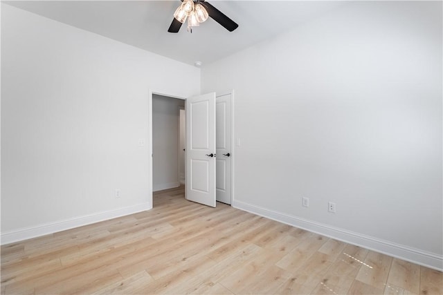 unfurnished bedroom with ceiling fan and light hardwood / wood-style floors