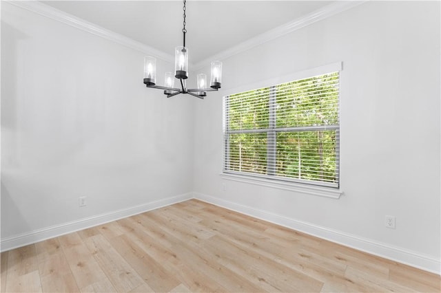 empty room featuring light hardwood / wood-style flooring, crown molding, and an inviting chandelier