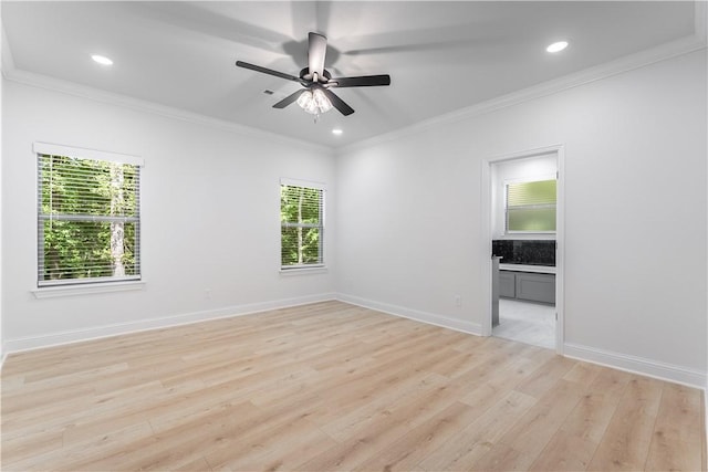 unfurnished room featuring ceiling fan, light hardwood / wood-style floors, and ornamental molding