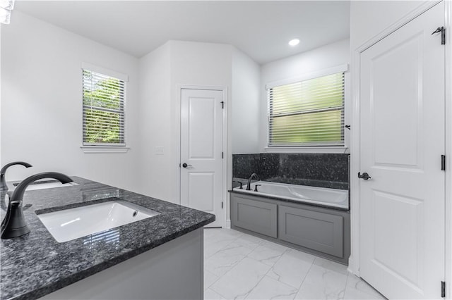 bathroom featuring vanity and a tub