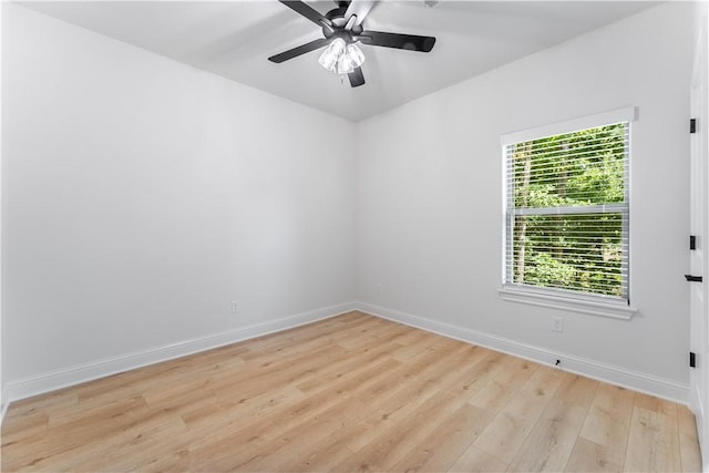 empty room with ceiling fan and light hardwood / wood-style floors