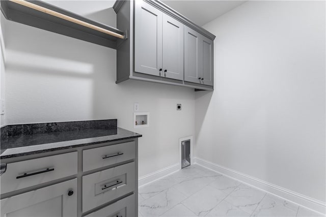 laundry area featuring hookup for an electric dryer, washer hookup, and cabinets