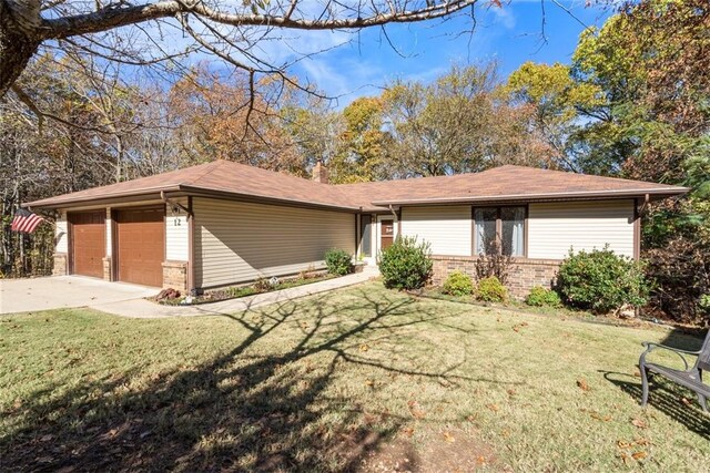 view of front of property with a front lawn and a garage