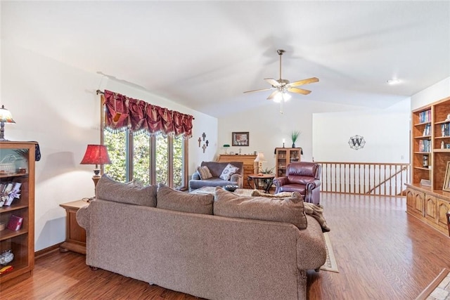 living room featuring vaulted ceiling, ceiling fan, and light wood-type flooring