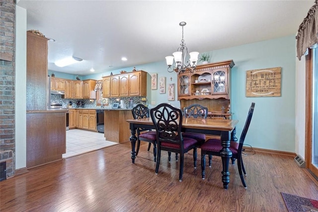 dining space featuring a chandelier and light hardwood / wood-style flooring