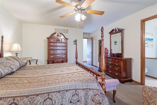 bedroom with light colored carpet, ceiling fan, and ensuite bathroom