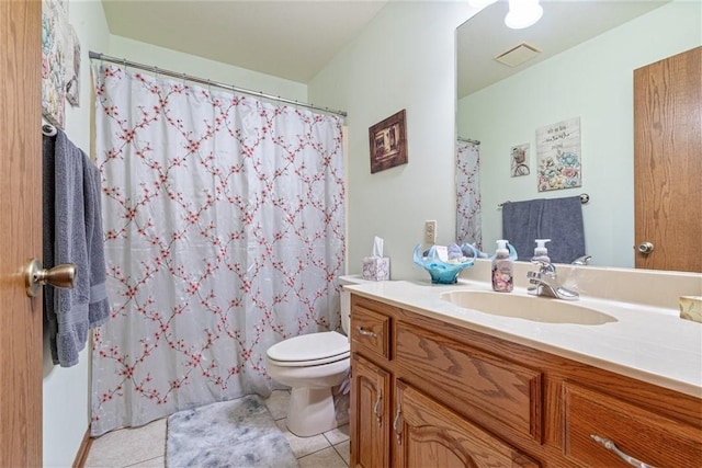 bathroom featuring tile patterned flooring, vanity, and toilet