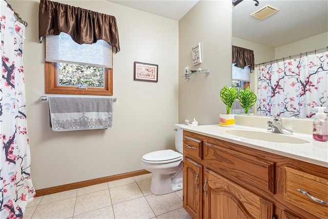 bathroom featuring tile patterned floors, vanity, and toilet