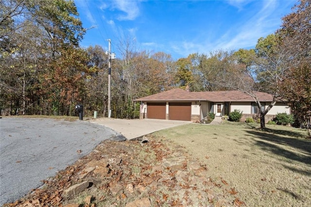 single story home with a garage and a front yard