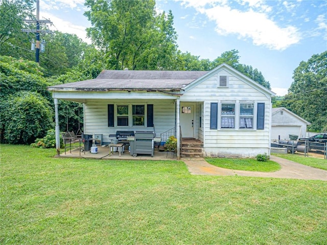 bungalow featuring a patio area and a front lawn