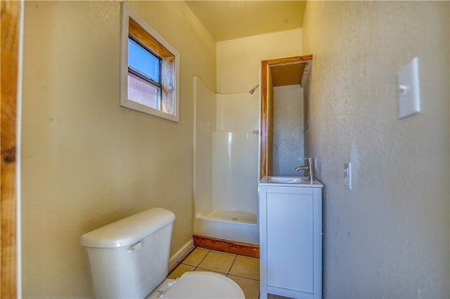 bathroom featuring walk in shower, vanity, toilet, and tile patterned floors