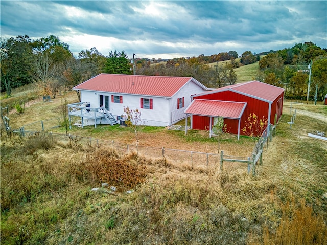 rear view of property featuring an outbuilding