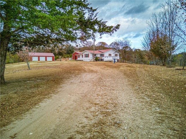 single story home featuring an outbuilding and a garage