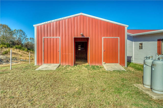 view of outbuilding with a lawn