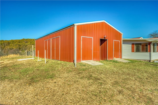 view of outbuilding featuring a yard