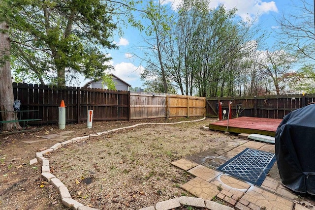 view of yard with a fenced backyard and a wooden deck