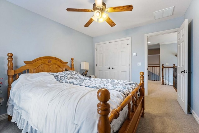 bedroom with ceiling fan, visible vents, baseboards, a closet, and carpet