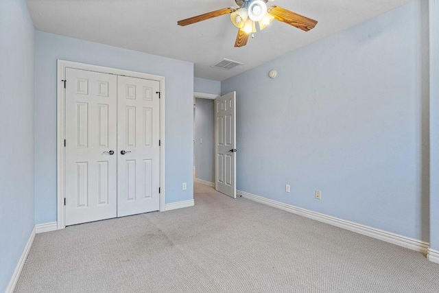 unfurnished bedroom with a closet, carpet flooring, visible vents, and baseboards