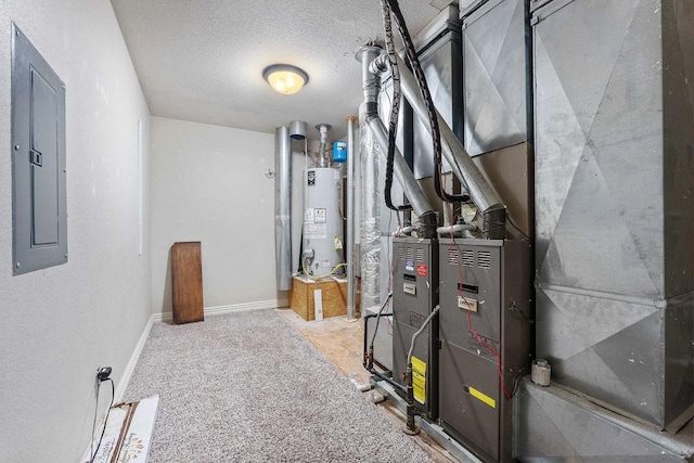 utility room featuring electric panel, heating unit, and water heater