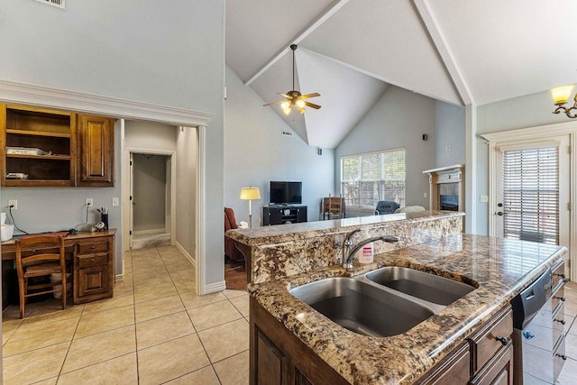 kitchen with light tile patterned flooring, a fireplace, a sink, a ceiling fan, and open floor plan