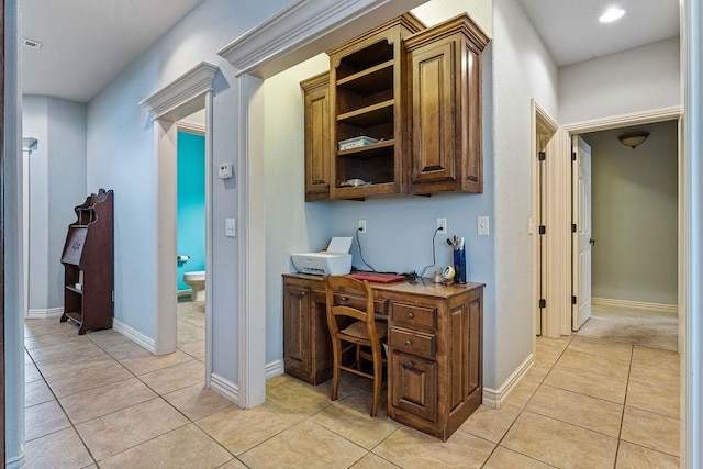 office featuring light tile patterned floors, visible vents, and baseboards