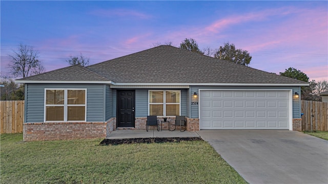 view of front of property with a lawn and a garage