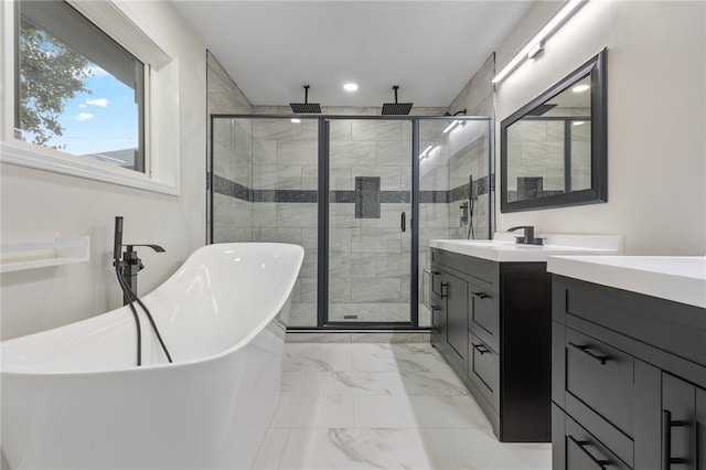 bathroom with recessed lighting, a shower stall, marble finish floor, a freestanding tub, and vanity