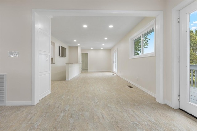 spare room featuring a wealth of natural light, recessed lighting, and baseboards