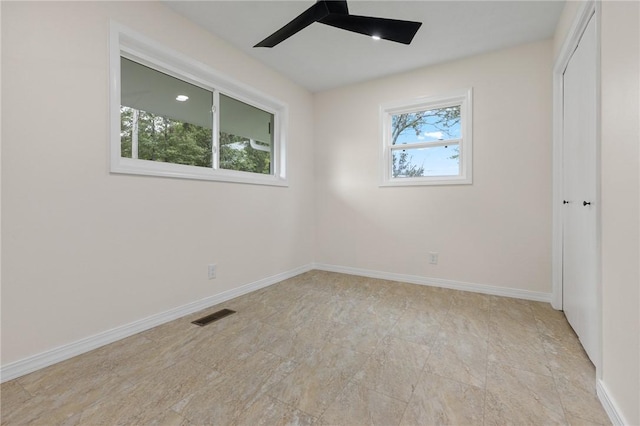 unfurnished bedroom with visible vents, ceiling fan, baseboards, and a closet