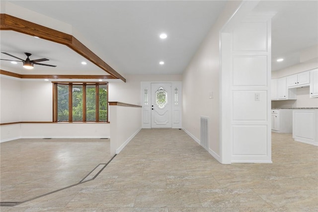 foyer featuring ceiling fan and beam ceiling