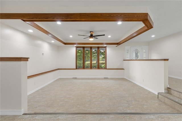 spare room with ceiling fan, recessed lighting, a tray ceiling, and baseboards